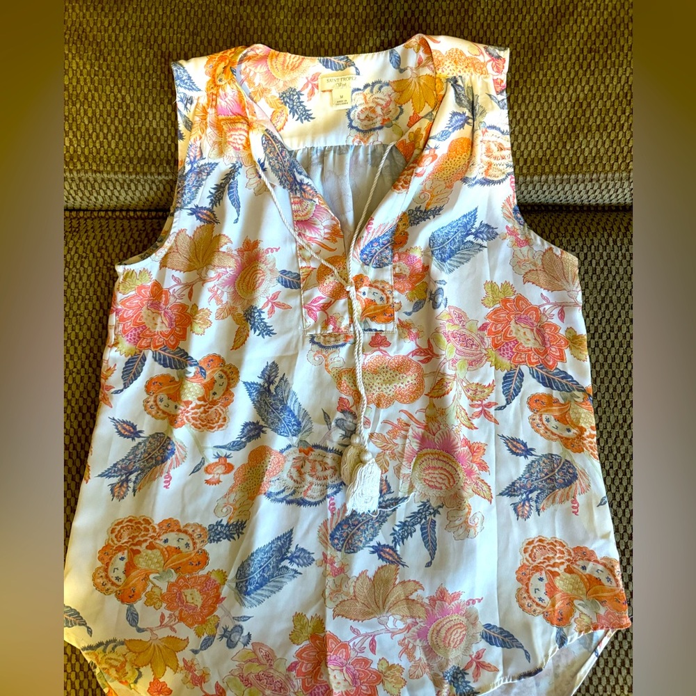 Sleeveless, summery top. Tassel detail. Beautiful colors.